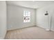 A simple bedroom with carpet flooring, a bright window, and minimal furniture at 5648 Juniper Ct, Whitestown, IN 46075
