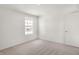 Bright bedroom features neutral carpet, a large window, and a standard size door at 5648 Juniper Ct, Whitestown, IN 46075