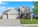 Charming two-story home features a blend of brick and stone, with a two car garage, and a well manicured lawn at 5648 Juniper Ct, Whitestown, IN 46075