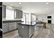 Contemporary kitchen featuring gray cabinets, a center island, and an open design that connects to other living spaces at 5648 Juniper Ct, Whitestown, IN 46075
