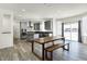 Bright modern kitchen with gray cabinets, stainless steel appliances, and a dining area with views of the yard at 5648 Juniper Ct, Whitestown, IN 46075