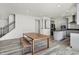 Open layout showcases the dining area and kitchen with gray cabinetry next to a staircase to the upper level at 5648 Juniper Ct, Whitestown, IN 46075