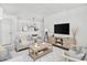 A bright living room boasts a large TV, modern decor, and comfortable seating at 5648 Juniper Ct, Whitestown, IN 46075