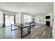 Spacious living room with a fireplace, comfortable seating, a dining area, and natural light from large windows at 5648 Juniper Ct, Whitestown, IN 46075