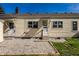 Rear view of the home and backyard with small decorative stones and a grassy area at 5757 E 21St St, Indianapolis, IN 46218