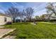 Spacious backyard surrounded by lush greenery and neighboring homes at 5757 E 21St St, Indianapolis, IN 46218