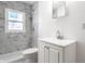 Bathroom with white marble tile shower and vanity with brushed nickel faucet at 5757 E 21St St, Indianapolis, IN 46218