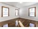 Bright bedroom with refinished hardwood floors and three windows with wood trim at 5757 E 21St St, Indianapolis, IN 46218