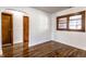 Bright bedroom featuring hardwood floors, fresh white paint, and multiple closets at 5757 E 21St St, Indianapolis, IN 46218