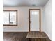 Bright foyer featuring a white front door, fresh white paint, and hardwood floors at 5757 E 21St St, Indianapolis, IN 46218