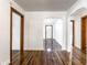 Inviting hallway with gleaming hardwood floors and arched doorways offer a warm welcome at 5757 E 21St St, Indianapolis, IN 46218