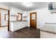 Bright kitchen features white cabinetry, granite counters and dark floors creating a modern space at 5757 E 21St St, Indianapolis, IN 46218