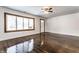 Spacious living room with hardwood floors, fresh white paint, and large window at 5757 E 21St St, Indianapolis, IN 46218