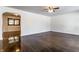 Spacious living room with shiny hardwood floors, white walls, and modern ceiling fan at 5757 E 21St St, Indianapolis, IN 46218