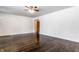 Bright living room featuring white walls, shiny hardwood floors, and ceiling fan at 5757 E 21St St, Indianapolis, IN 46218