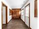 Hallway with wood-look floors, windows, doors, and closet with bi-fold doors at 5757 E 21St St, Indianapolis, IN 46218