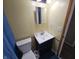 Bathroom featuring vanity, sink, and toilet with tiled floors at 5816 Coppock Ln, Indianapolis, IN 46221