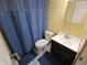 Bathroom featuring vanity, sink, and toilet with blue shower curtain at 5816 Coppock Ln, Indianapolis, IN 46221