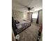 View of the bedroom with neutral carpet, ceiling fan, and decorative wall features at 5816 Coppock Ln, Indianapolis, IN 46221