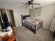 Bedroom features a ceiling fan, closet, and dresser with mounted television at 5816 Coppock Ln, Indianapolis, IN 46221