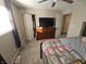 Bedroom features a ceiling fan, closet, and dresser with mounted television at 5816 Coppock Ln, Indianapolis, IN 46221