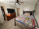 Bedroom features a ceiling fan, closet, and dresser with mounted television at 5816 Coppock Ln, Indianapolis, IN 46221