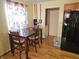 Bright eat-in kitchen featuring light walls, dark wood table set and black refrigerator at 5816 Coppock Ln, Indianapolis, IN 46221