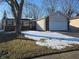 Charming one-story home with attached garage and brick facade, set against a wintery backdrop at 5816 Coppock Ln, Indianapolis, IN 46221