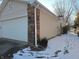 This home has a 2-car garage with brick and vinyl siding at 5816 Coppock Ln, Indianapolis, IN 46221