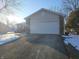 View of the 2-car garage, driveway, and partial house exterior at 5816 Coppock Ln, Indianapolis, IN 46221