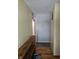 Hallway features sleek wood floors and a convenient wooden shelving unit, enhancing the entryway's functionality at 5816 Coppock Ln, Indianapolis, IN 46221