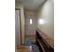 Inviting hallway with wood floors and a rustic wood shelf, leading to a bright front door at 5816 Coppock Ln, Indianapolis, IN 46221