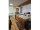 Bright kitchen featuring stainless steel sink, wooden cabinets, and modern appliances at 5816 Coppock Ln, Indianapolis, IN 46221