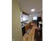 Open kitchen featuring warm wood cabinetry, stainless steel sink, and a breakfast bar overlooking dining area at 5816 Coppock Ln, Indianapolis, IN 46221