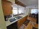 Kitchen with light wood cabinets and stainless-steel appliances, blending style with function at 5816 Coppock Ln, Indianapolis, IN 46221