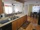 Bright kitchen featuring stainless steel sink, wooden cabinets, and modern appliances at 5816 Coppock Ln, Indianapolis, IN 46221