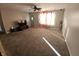 Spacious living room with plush carpeting, ceiling fan, and lots of natural light at 5816 Coppock Ln, Indianapolis, IN 46221