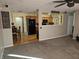 Open-concept living room with plush carpeting, large window and adjoining kitchen at 5816 Coppock Ln, Indianapolis, IN 46221