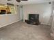 Open-concept living room with plush carpeting, large window and adjoining kitchen at 5816 Coppock Ln, Indianapolis, IN 46221