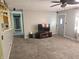 Cozy living room featuring neutral paint, plush carpet and a ceiling fan at 5816 Coppock Ln, Indianapolis, IN 46221