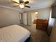 Main bedroom with a ceiling fan, dresser and an ensuite bathroom at 5816 Coppock Ln, Indianapolis, IN 46221