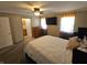 Main bedroom with a ceiling fan, dresser and a mounted TV at 5816 Coppock Ln, Indianapolis, IN 46221