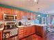 Well-lit kitchen with stainless steel appliances, wood cabinets, and ample counter space at 5944 Streamwood Ln, Indianapolis, IN 46237