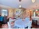 Cozy living area with hardwood floors, a staircase, and a view into the dining area at 5944 Streamwood Ln, Indianapolis, IN 46237