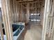 Bathroom under construction, featuring wood framing for the shower and tub, illustrating the early stages of bathroom design at 618 Firefly Ct, Greenfield, IN 46140