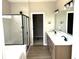 Modern bathroom with a glass-enclosed shower, double vanity, and stylish fixtures at 618 Firefly Ct, Greenfield, IN 46140