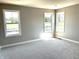 Bedroom with neutral walls, carpet, and three windows overlooking the outside at 618 Firefly Ct, Greenfield, IN 46140