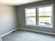 Bedroom with neutral walls, carpet, and a view of the neighborhood from the window at 618 Firefly Ct, Greenfield, IN 46140