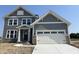 Two-story home with a gray siding, stone accents, white trim, and a two-car garage at 618 Firefly Ct, Greenfield, IN 46140