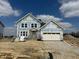 New construction two-story home featuring a two-car garage, visible framing, and covered with protective wrap awaiting final exterior at 618 Firefly Ct, Greenfield, IN 46140